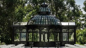 Black vintage dome hot-dip galvanized steel sunroom, wedding glass conservatory nestled in lush green woodland